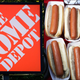 On left, a sign for The Home Depot; on right, a bunch of plain hot dogs in paper serving boats